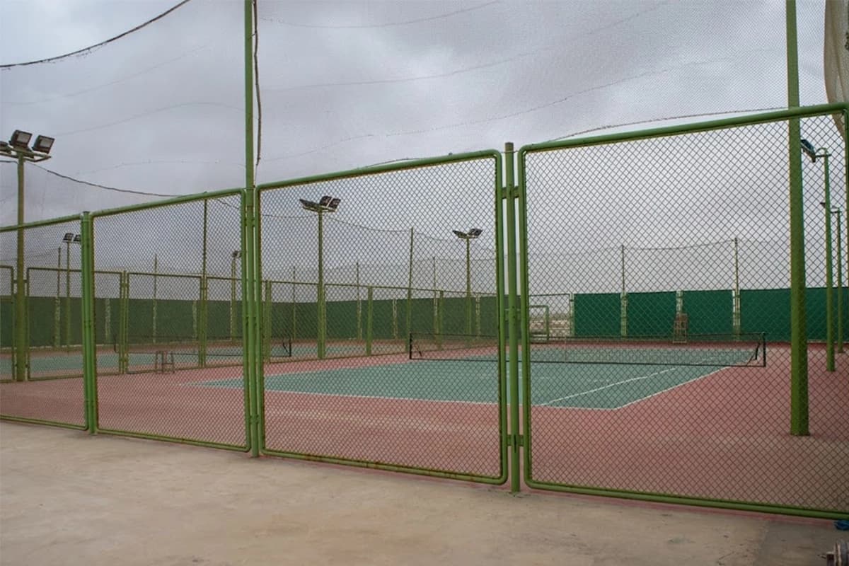 Tennis court fenced enclosure