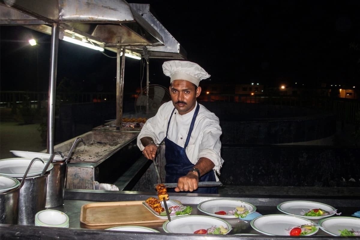 Rooftop bbq area chef grilling